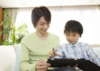Father and son using tablet PC