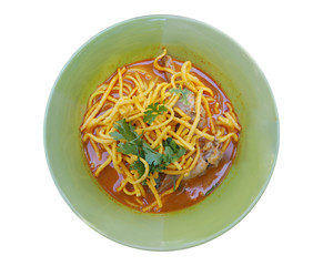 Curried Noodle Soup with Chicken (Khao Soi) in green bowl isolat