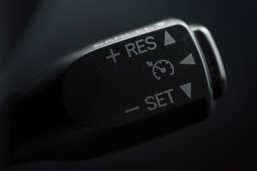 Speed limitation control buttons on modern car. Interior detail.