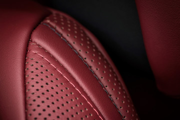 Modern car interior detail. Leather seat with stitch. Macro.