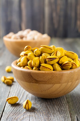 Salted pistachios with saffron in a bamboo plate. Selective focus.