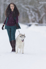 Human and Pet Relationships Ideas and Concepts.Lovely Caucasian Female With Her Highbred Husky Dog