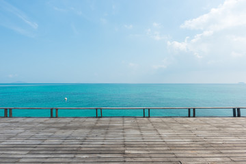 Obraz na płótnie Canvas wooden floor with beautiful ocean and blue sky scenery