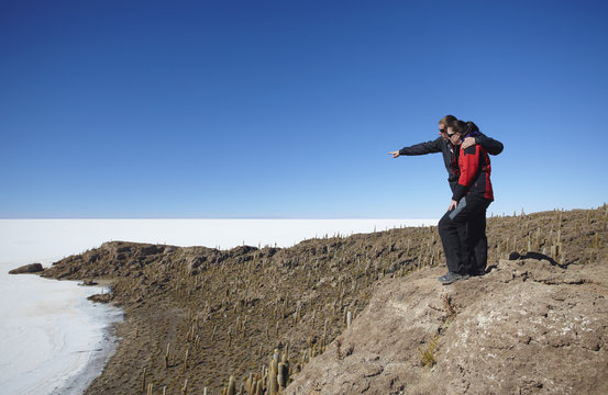 Couple at Isla del Pescado (Fish Island) on Salar de Uyuni (Salt Flats of Uyuni), Potosi Department, Bolivia
