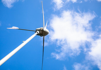 View from below of a windmill for electric power production. Outdoor on summer day.