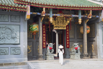 Woman wearing ao dai dress at Nghia An Hoi Quan Pagoda, Cholon, Ho Chi Minh City, Vietnam