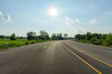 Fototapeta premium asphalt road and sun on blue sky