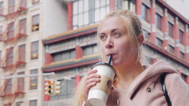 Young tourist drink bubble tea in Chinatown New York, USA