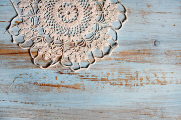 handmade lace on shabby chic, painted, blue wood. Macrame close-up, top view with copy space. Wedding or holiday background. - obrazy, fototapety, plakaty