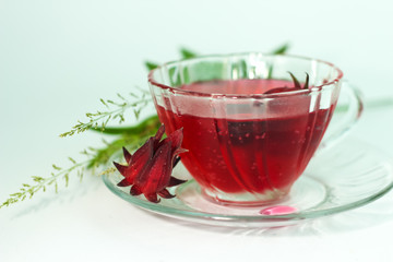 Glass of cold roselle juice - healthy food against wood
