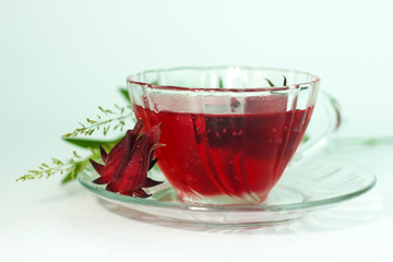 Glass of cold roselle juice - healthy food against wood