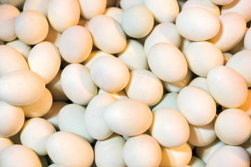 Eggs, background, pattern, protein, diet, natural. Background pattern of multiple small white eggs viewed as a layer from above. Many hens eggs on background.