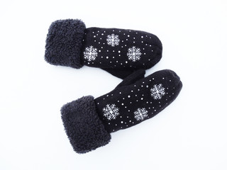 mittens winter clothes on snow background