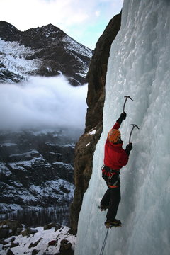 An ice climber makes his way up a frozen waterfall near Cogne, above the Aosta Valley, northern Italy