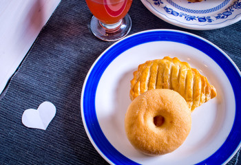 donut and bagel for breakfast or snack with a glass of orange ju