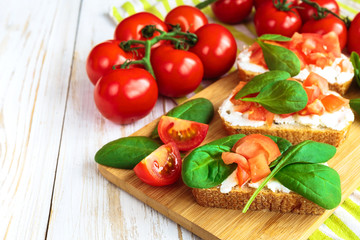 Bruschetta with spinach and cherry tomatoes on toasted baguette