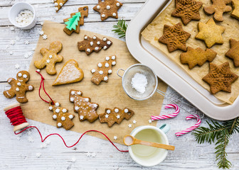 Christmas homemade gingerbreads and Christmas spices on a wooden background. 
