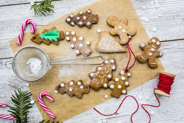 Christmas homemade gingerbreads and Christmas spices on a wooden background. 
