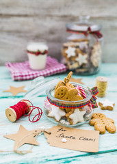 Homemade Christmas cookies in a jar on wooden rustic background. 
