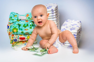 Cute baby with money isolated on blurry diapers background