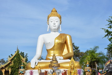 Fototapeta premium holy big white Buddha image in Wat Phrathat Doi Kham ancient temple in Thailand