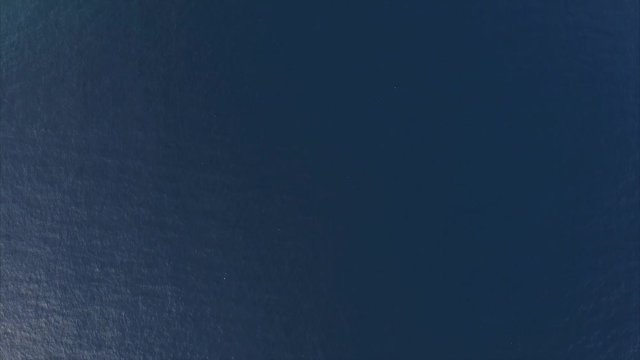 Aerial shoot of a calm lagoon with boats and buildings. Bali, Indonesia. Accelerate 2x