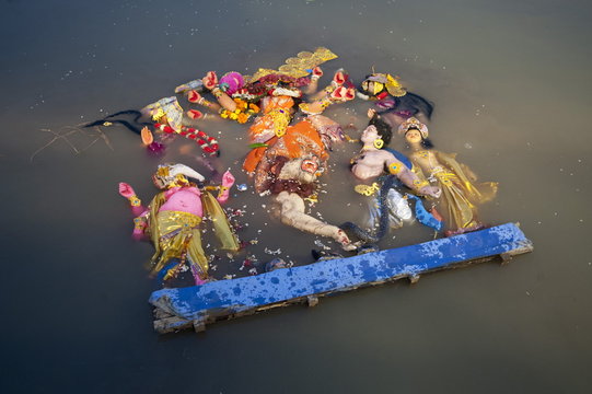 Durga puja deity, made from river mud and decorated, in the Brahmaputra River at Hindu Durga puja immersion ceremony, Guwahati, Assam