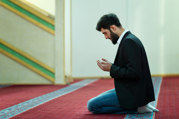 Fototapeta premium Young beautiful Muslim Man Praying In Mosque