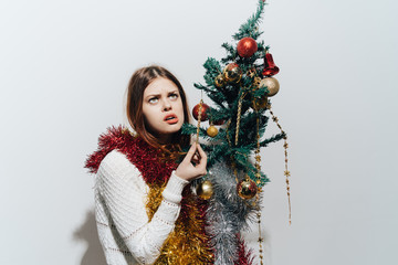 woman hugging a Christmas tree sown New Year's holiday celebrations
