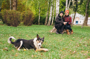 couple walking a dog park