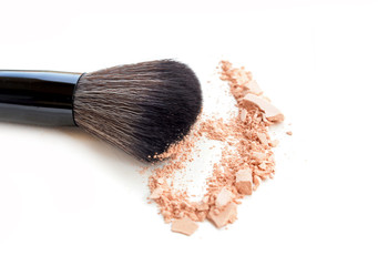 Face powder and brush on white background