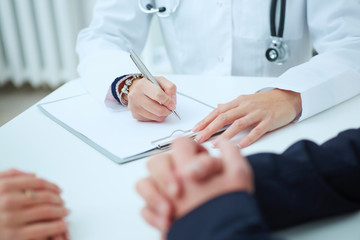 Close up of patients hands and doctor taking notes. Ward round, patient visit check, medical calculation and statistics concept. Physician ready to examine patient - obrazy, fototapety, plakaty
