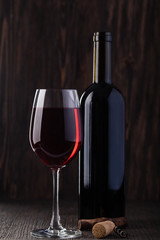 Bottle of red wine and corkscrew