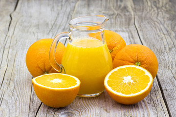 Fototapeta na wymiar orange juice and fresh fruits on wooden background