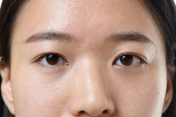 Naklejka premium Close up of the calm eyes of a Chinese woman
