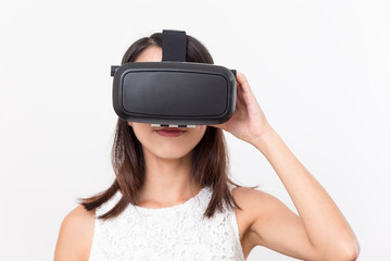 Young girl lookinh with VR device