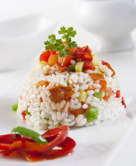 Rice with red pepper and green peas