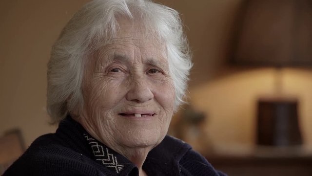 Old lady nods and smiles to the camera
