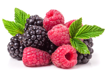 pile of raspberries and blackberries with leaves isolated on white background