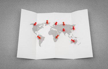 Paper folded world map  with red Pin Pointer .
