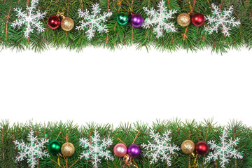 Christmas frame made of fir branches decorated with colored balls and snowflakes isolated on white background