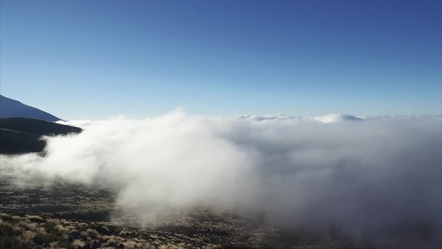 Panoramic footage of low clouds surrounding Mount Teide Volcano, Tenerife, Canary Islands, Spain.