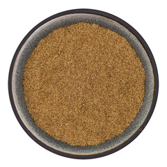 Organic ground cumin in ceramic bowl isolated on white background, top view