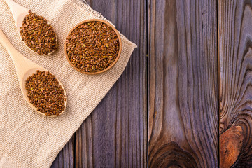 Brown flax seeds or flax seed in a small bowl on sacking