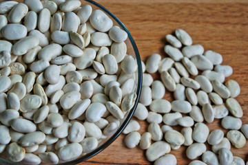 White beans in a bowl on a wooden table