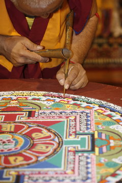 Buddhist monk drawing a mandala, Paris, Ile de France, France