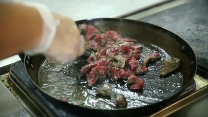 The process of cooking in the dining room.