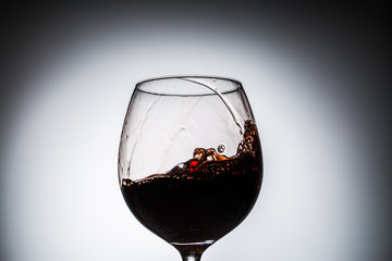 Stream of wine being pouring into a glass.