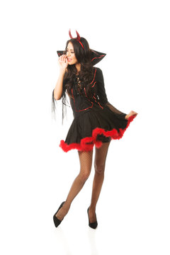 Full length woman wearing devil clothes whispering to someone