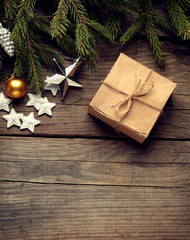 Christmas tree with gift box and decorations on wooden backgroun